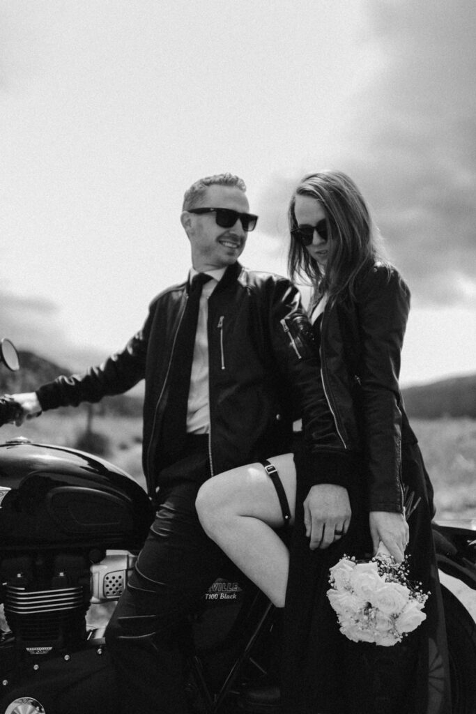 Biker couple takes wedding photos in the mountains on a motorbike