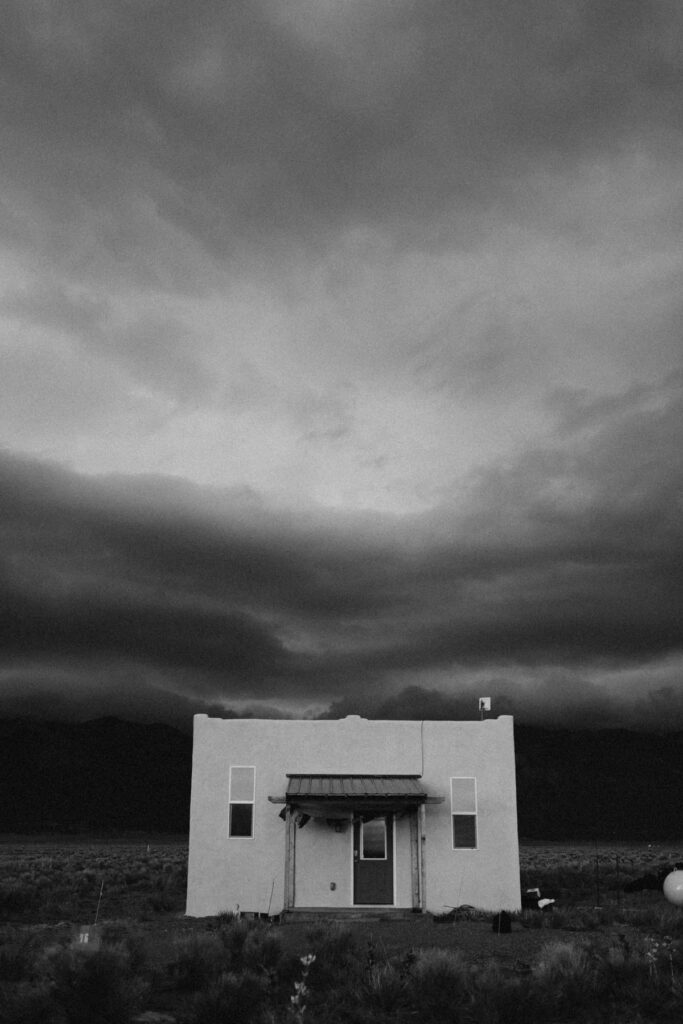 Adobe home in the high desert with moody sky