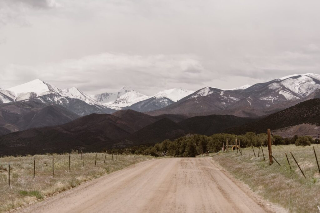 White capped Colorado mountain views from a motorbike wedding