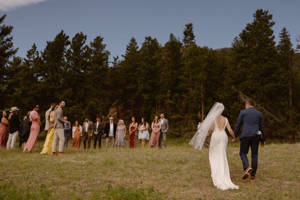 Bride and father of the bride walking up to ceremony in RMNP