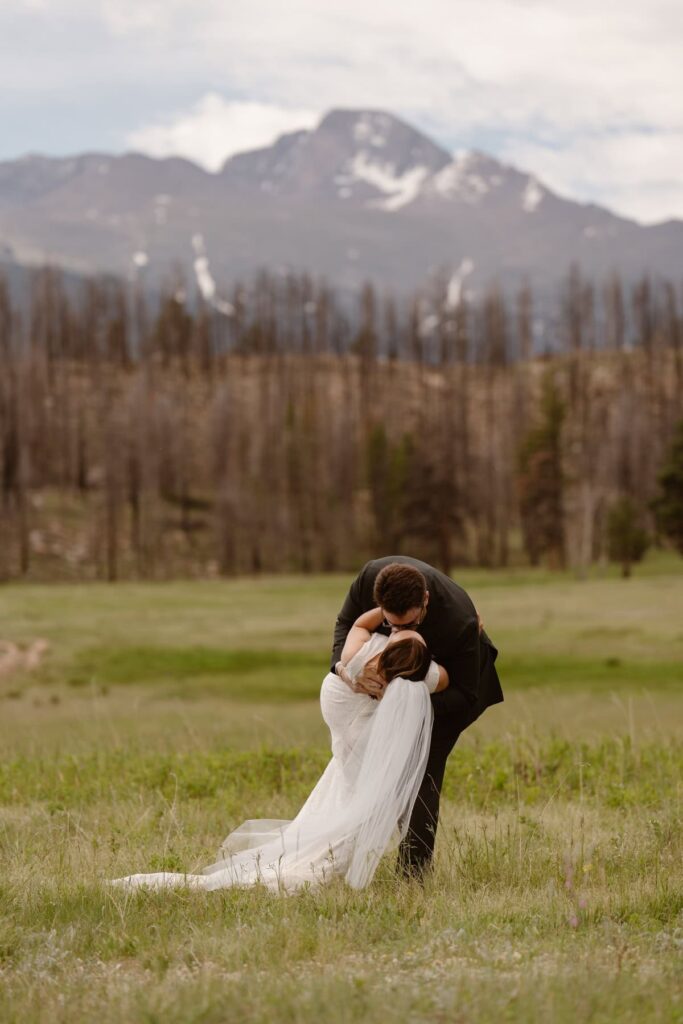 First kiss and dip during wedding ceremony in Rocky Mountain National Park