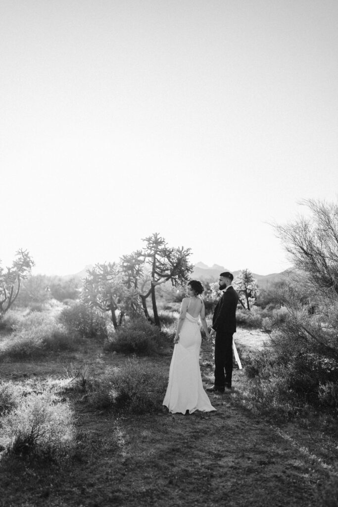 Couple wandering the hiking trails at Lost Dutchman State Park on their wedding day