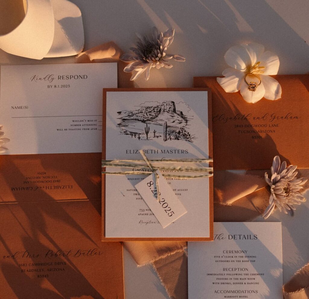 Wedding day details include burnt orange wedding invites and stationary