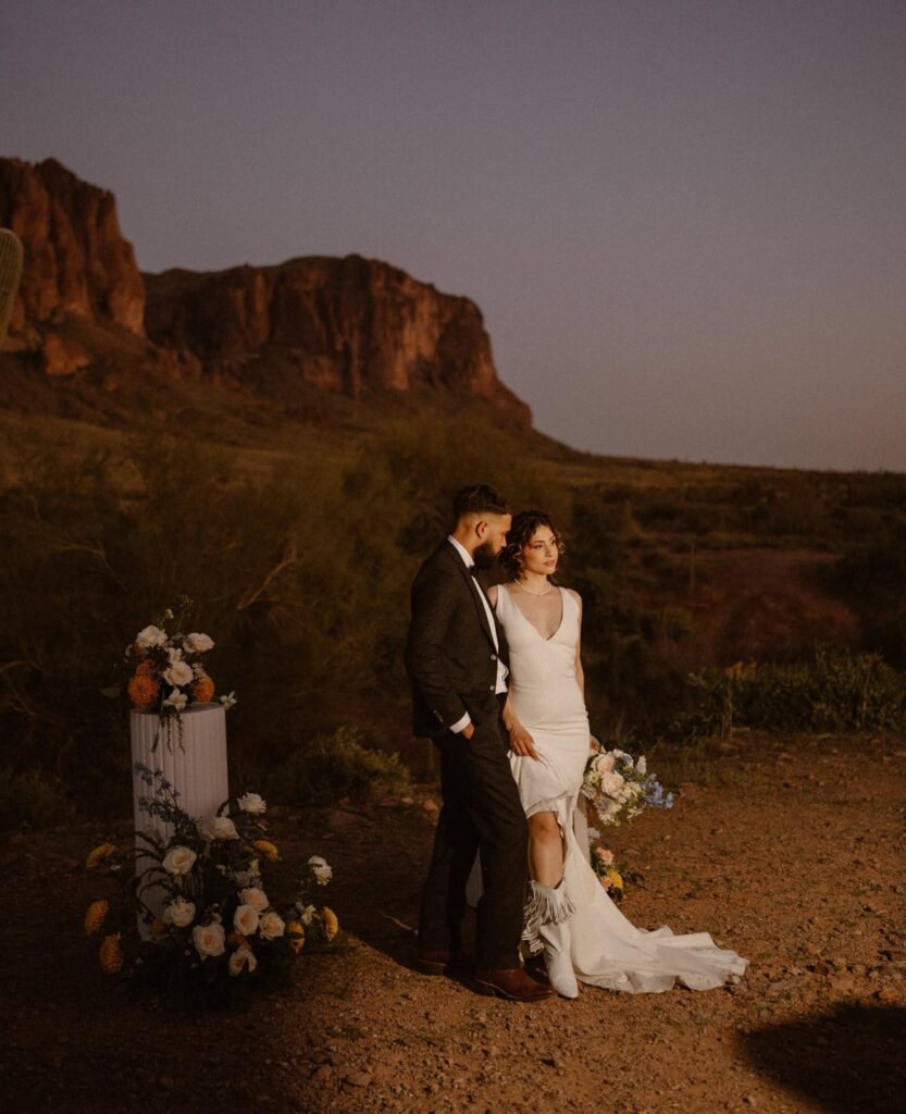 Bride shows off her cowboy boots at desert elopement at Lost Dutchman State Park