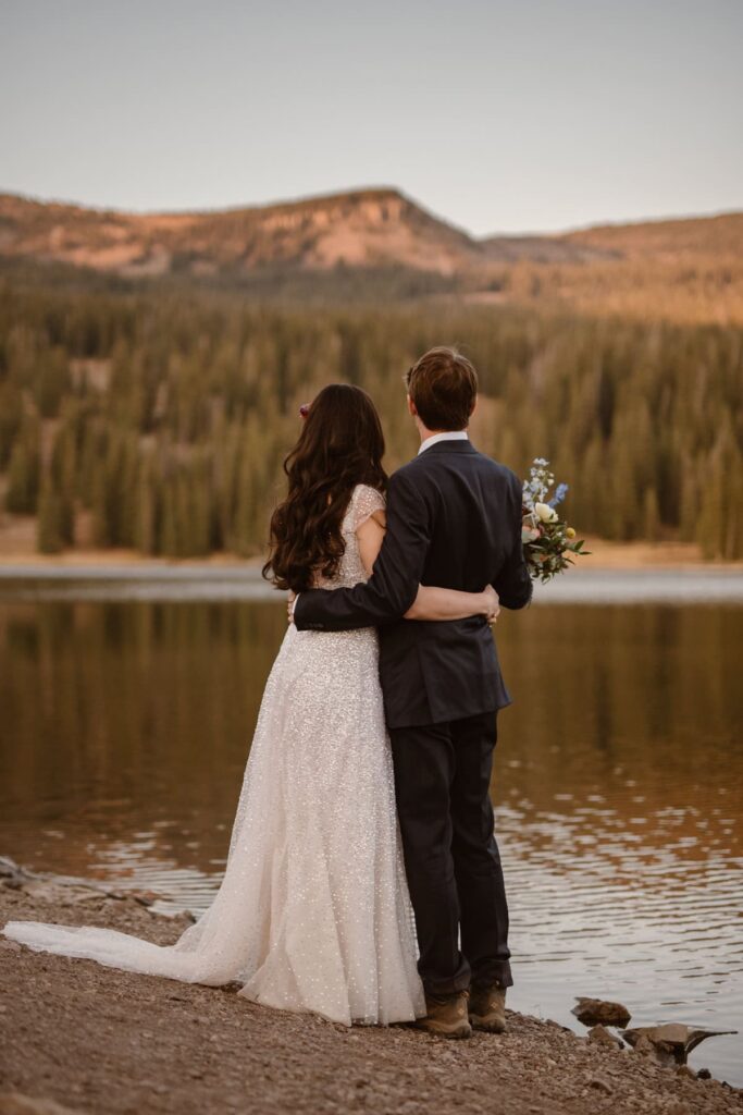 Couple looking off into the mountains of Colorado on their wedding day