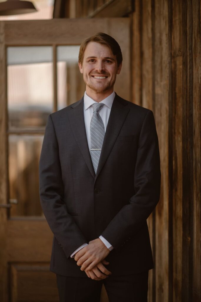 Groom in a dark blue suit on his wedding day