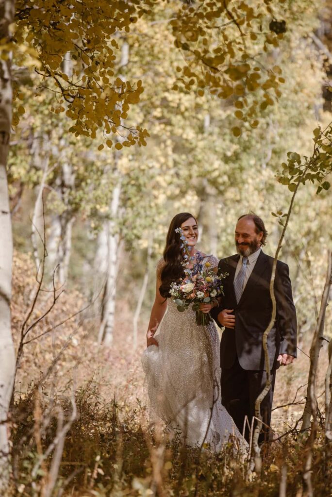 Bride and father walking down the hiking trail as the aisle