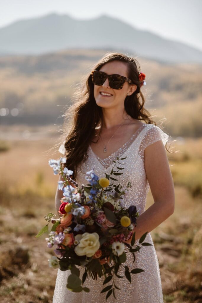 Bride with sunglasses on holding her bouquet