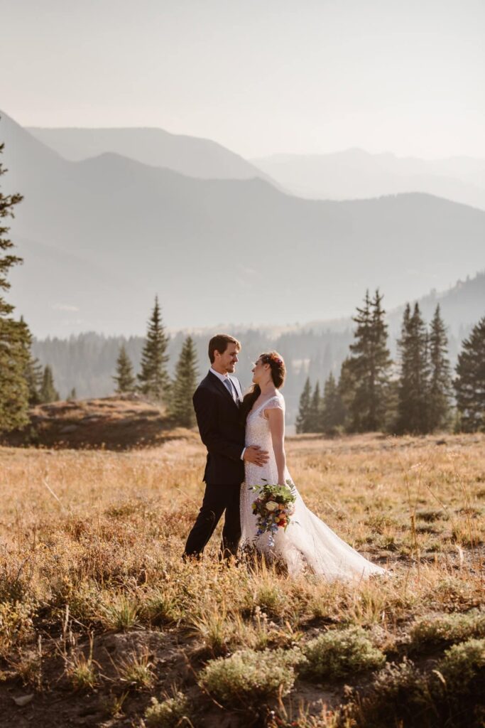 Couple in a mountain meadow on their wedding day