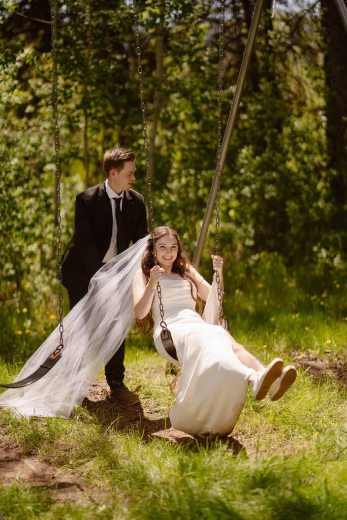 Bridal photos in the forest on a swingset