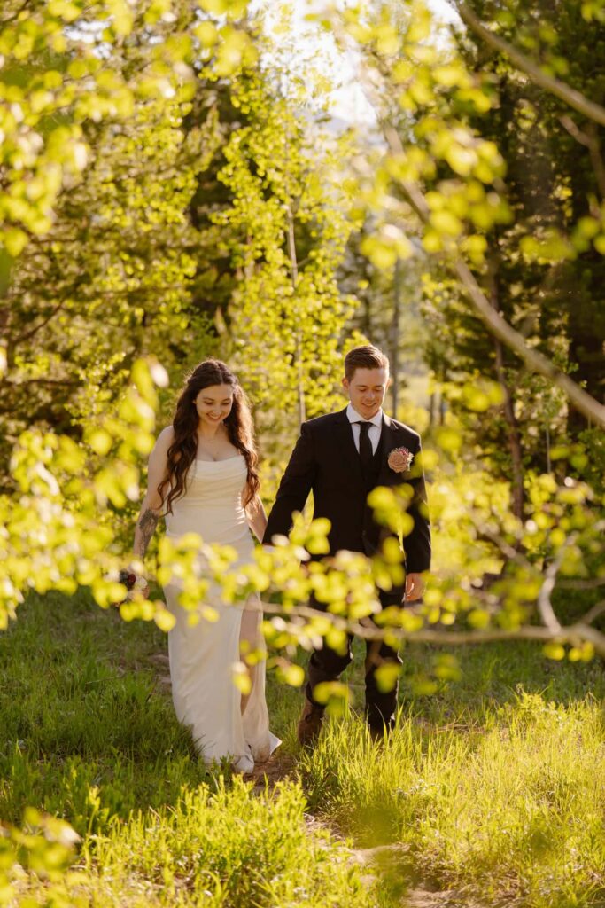 Couple hiking through an aspen grove