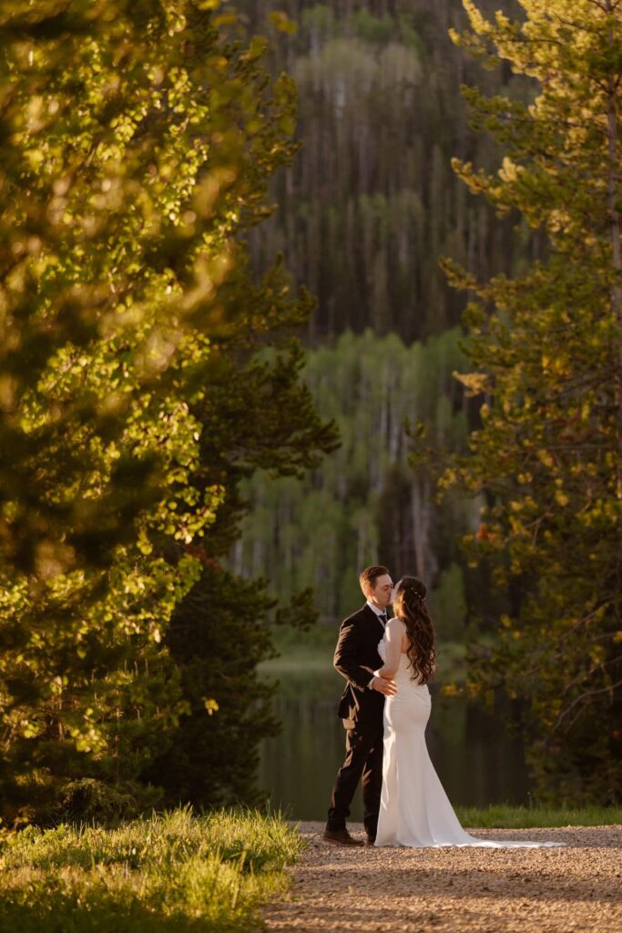 Couple sharing a kiss before their wedding ceremony