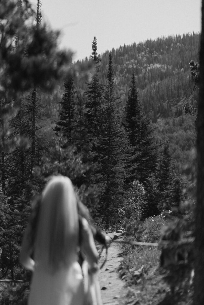 Bride hiking through a Colorado forest