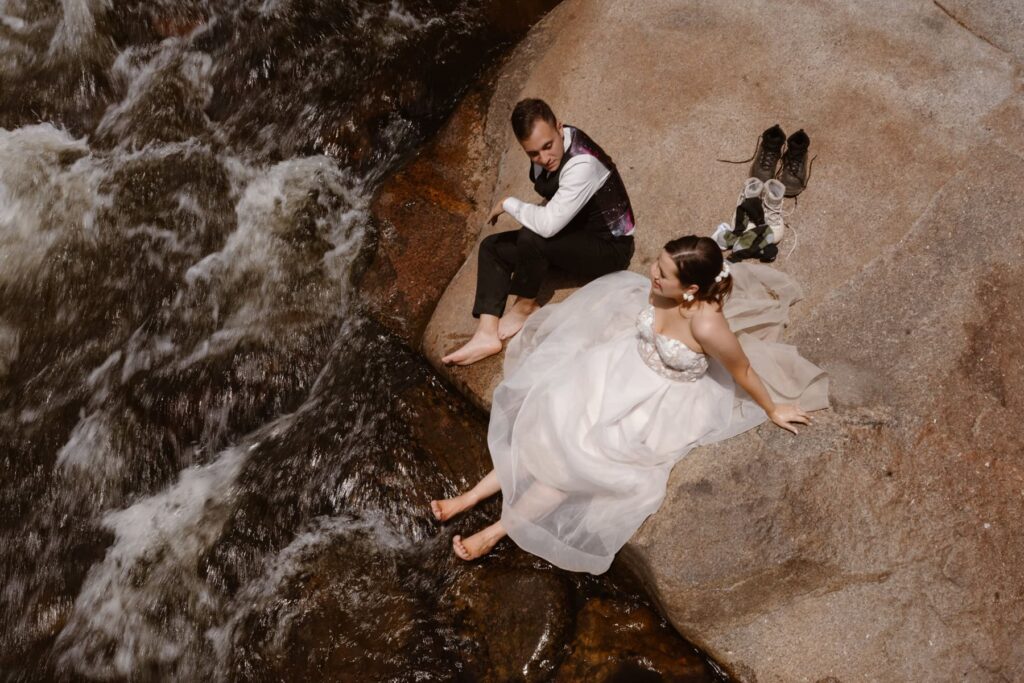 Bride and groom dipping their feet in the water