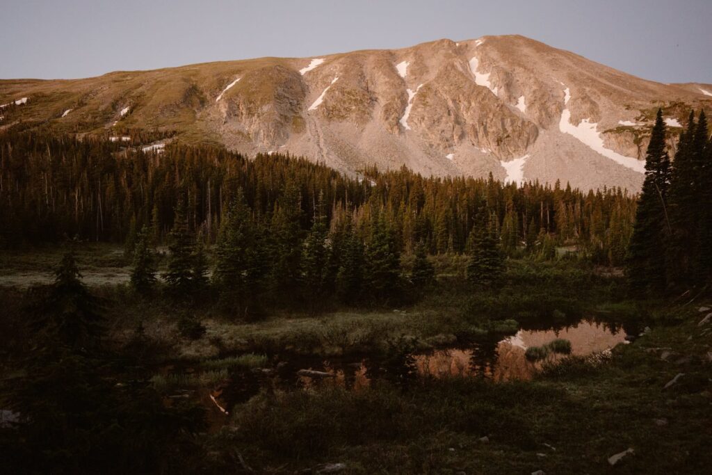 View of mountains surrounding Lake Isabelle at alpenglow