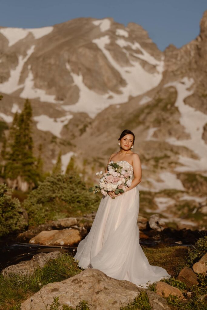 Bride with bouquet in the mountains