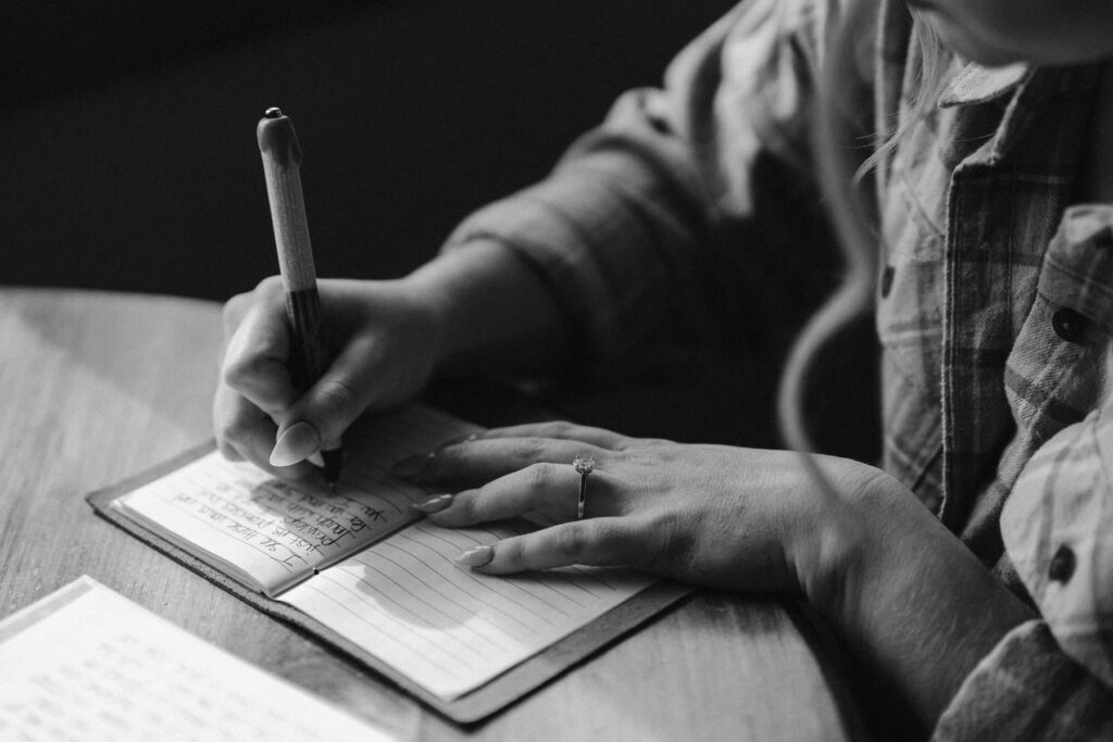 Bride writing in her vow book