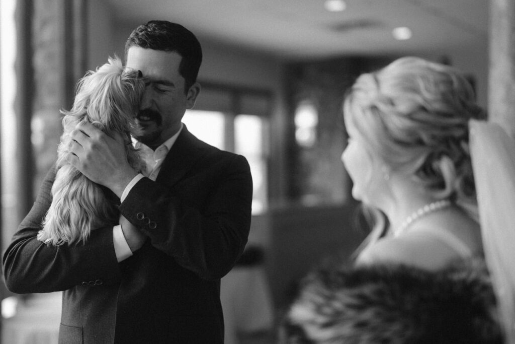 Dog licking the groom's face