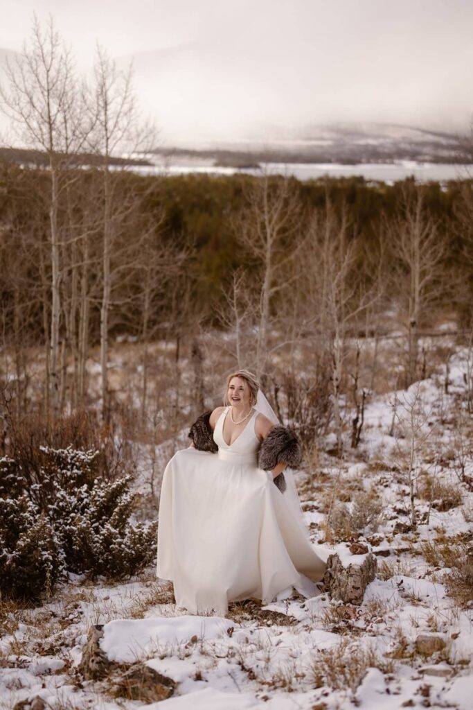 Bride walking through the snow in wedding dress