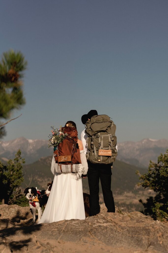 Bride and groom with their hiking packs