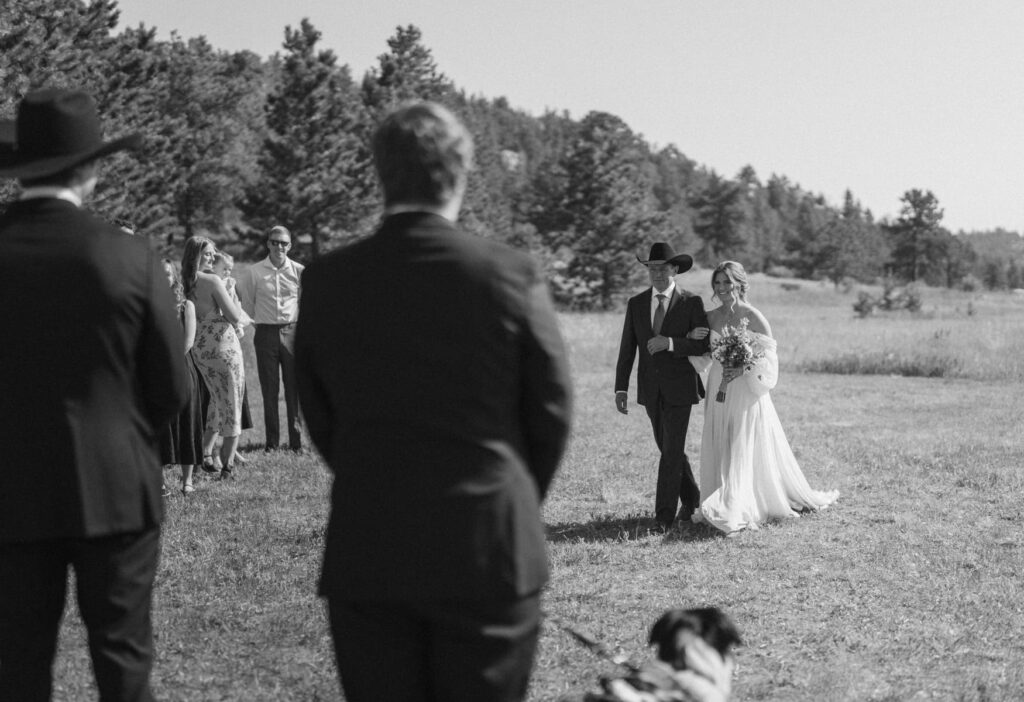 Bride and father of the bride walking down the aisle