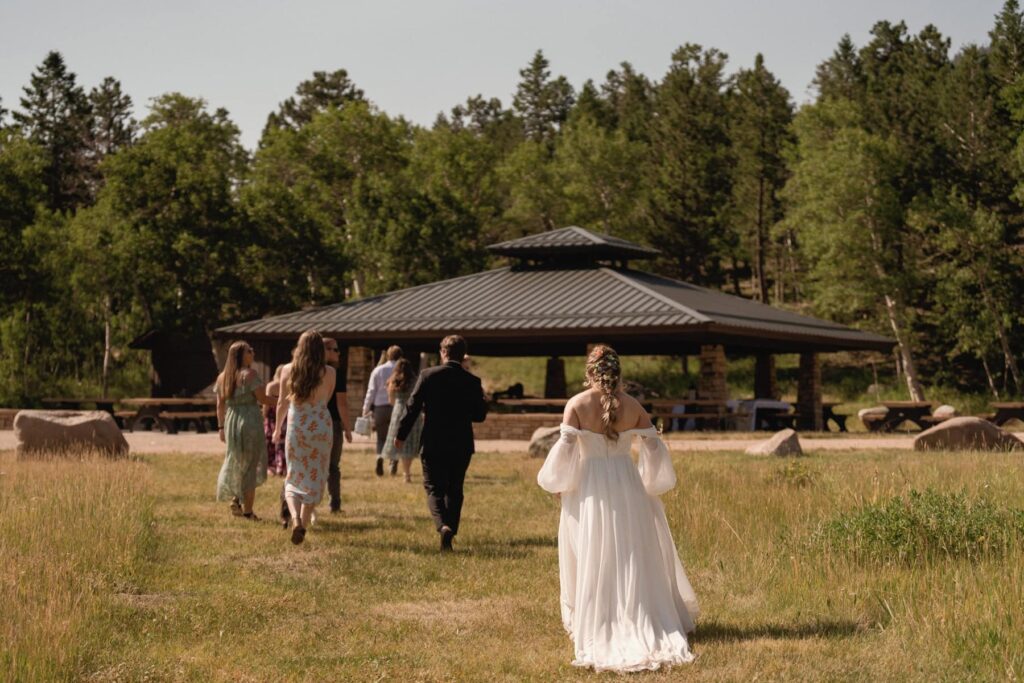 Wedding party walking toward the pavilion