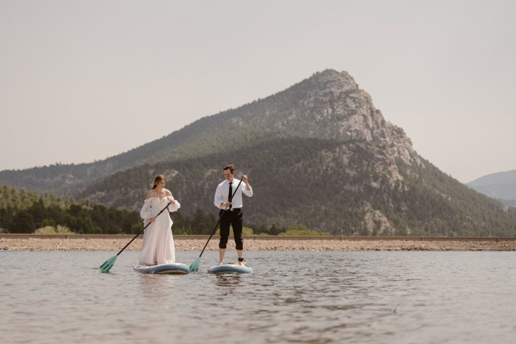 Bride and groom paddleboarding on Lake Estes