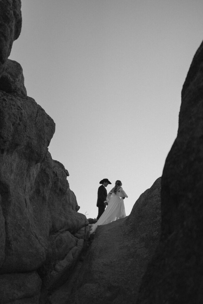 Bride and groom walking out to summit