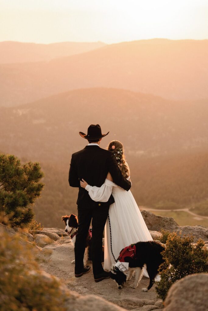 Bride and groom looking out into the mountains