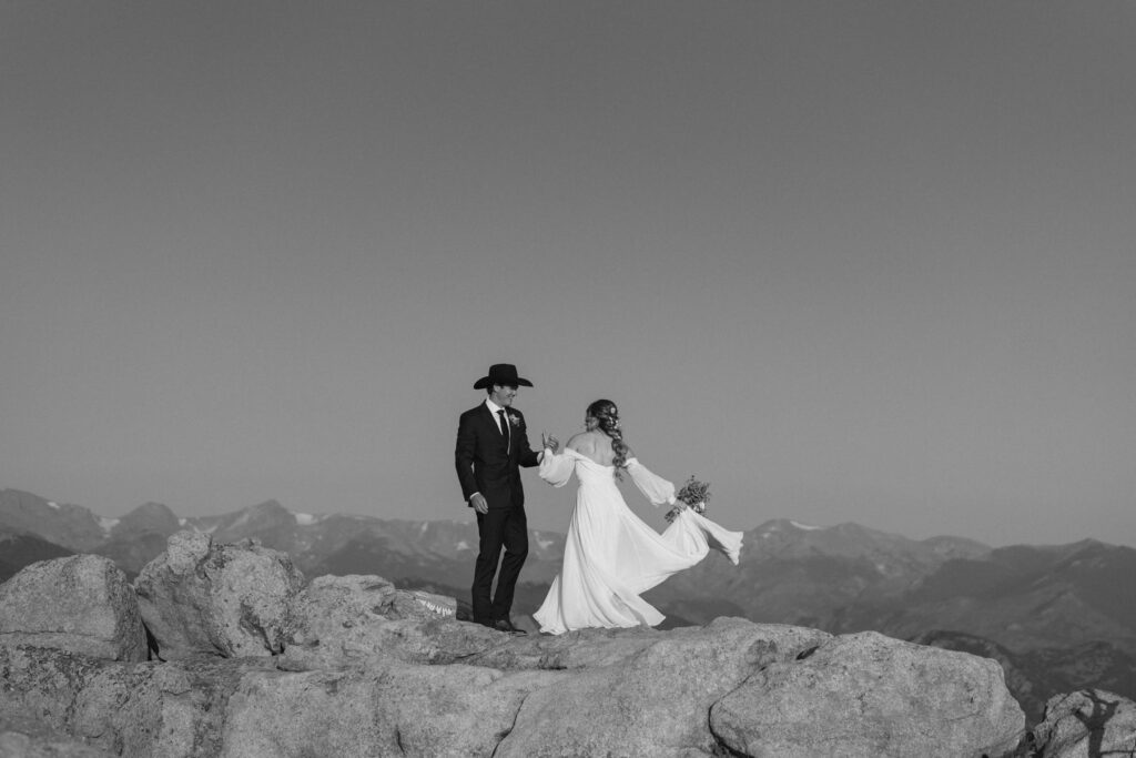 Bride and groom dancing on the mountain