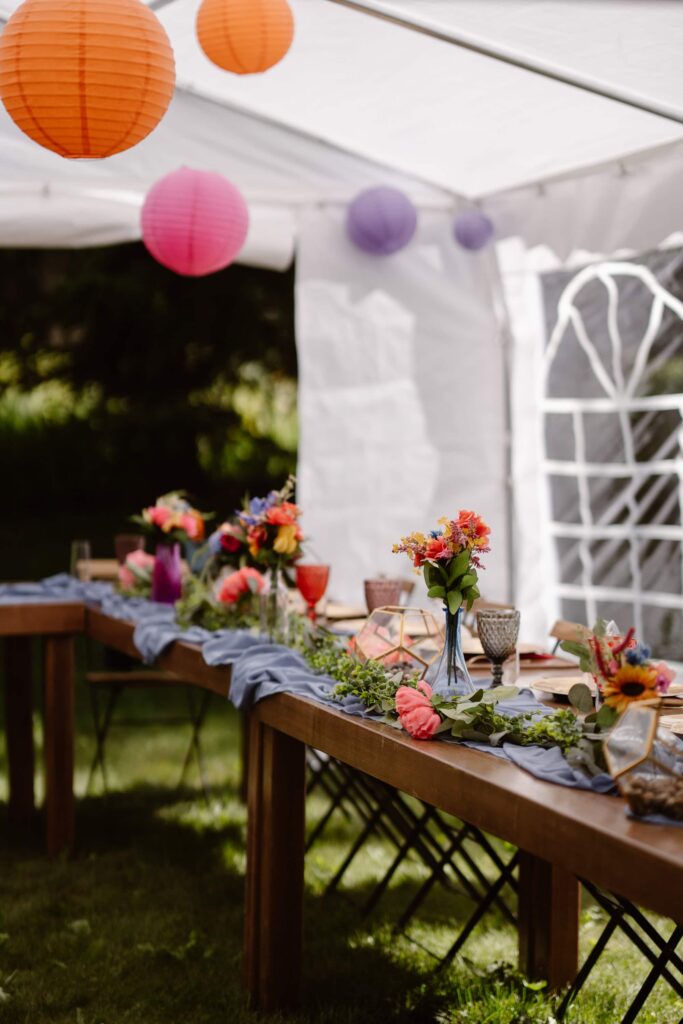 Colorful outdoor wedding reception under tent