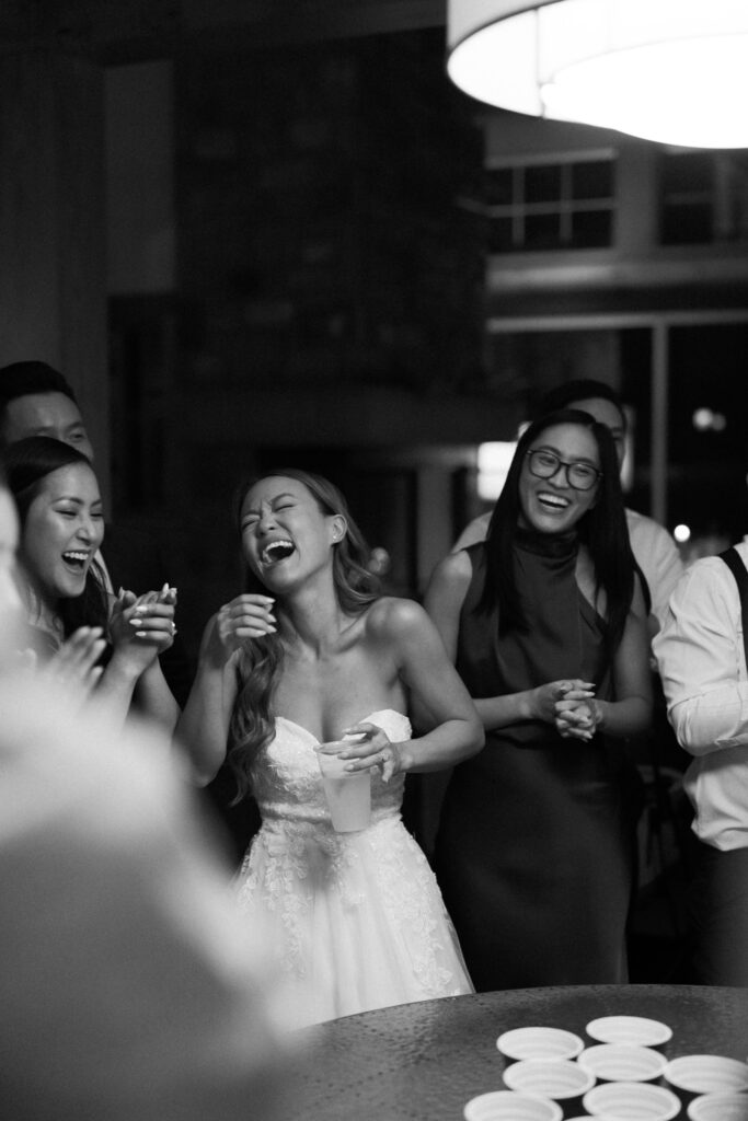 Laughing and playing games at Telluride Airbnb wedding reception
