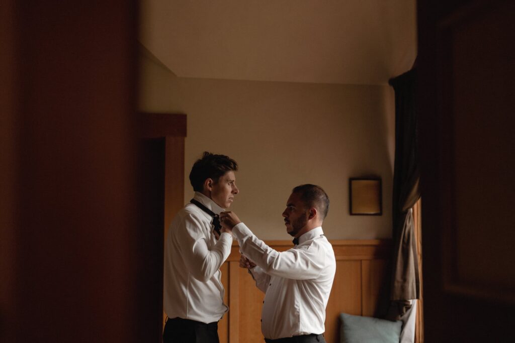 Best man and groom getting ready