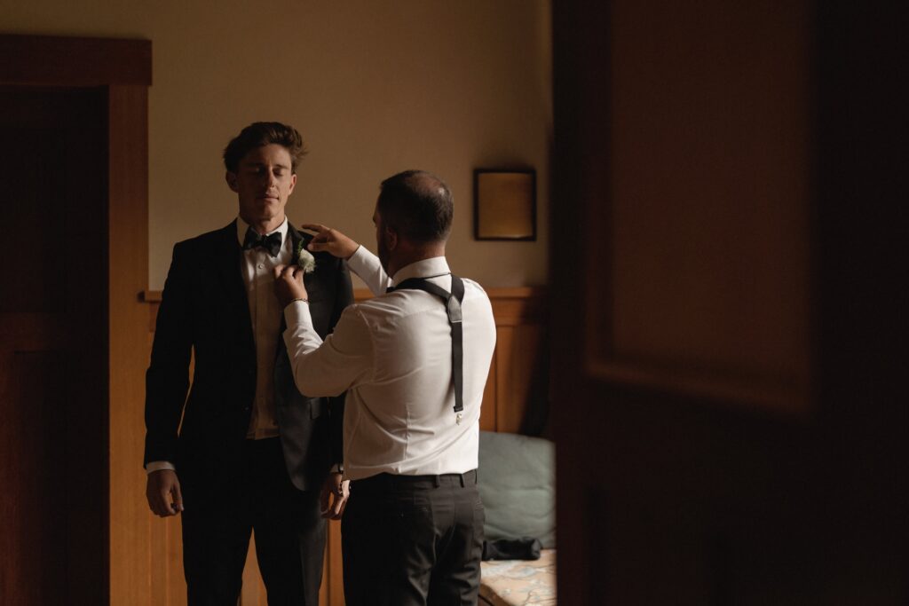 Best man helping groom get ready at Telluride Airbnb wedding location