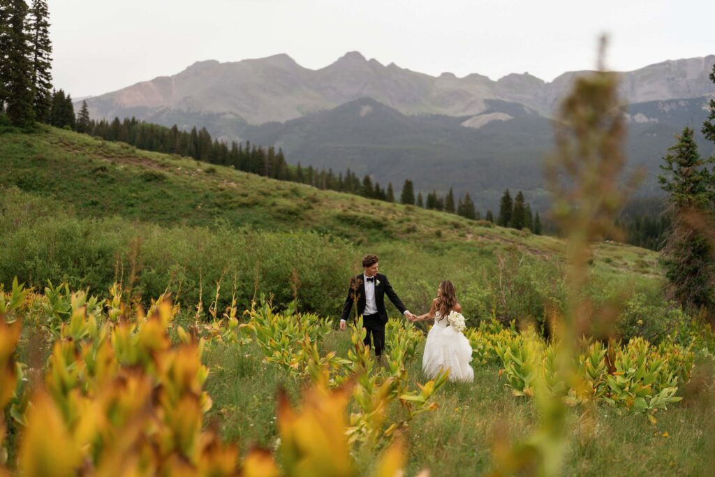 Bride and groom in the lush mountains