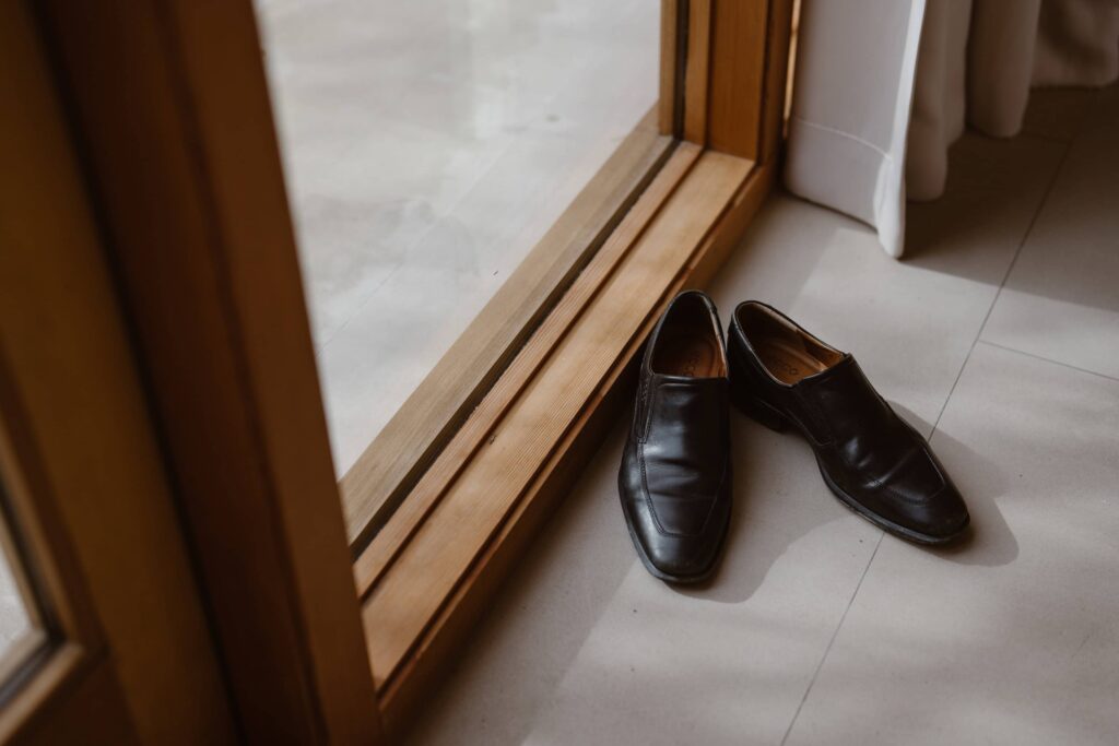 Groom's black loafer