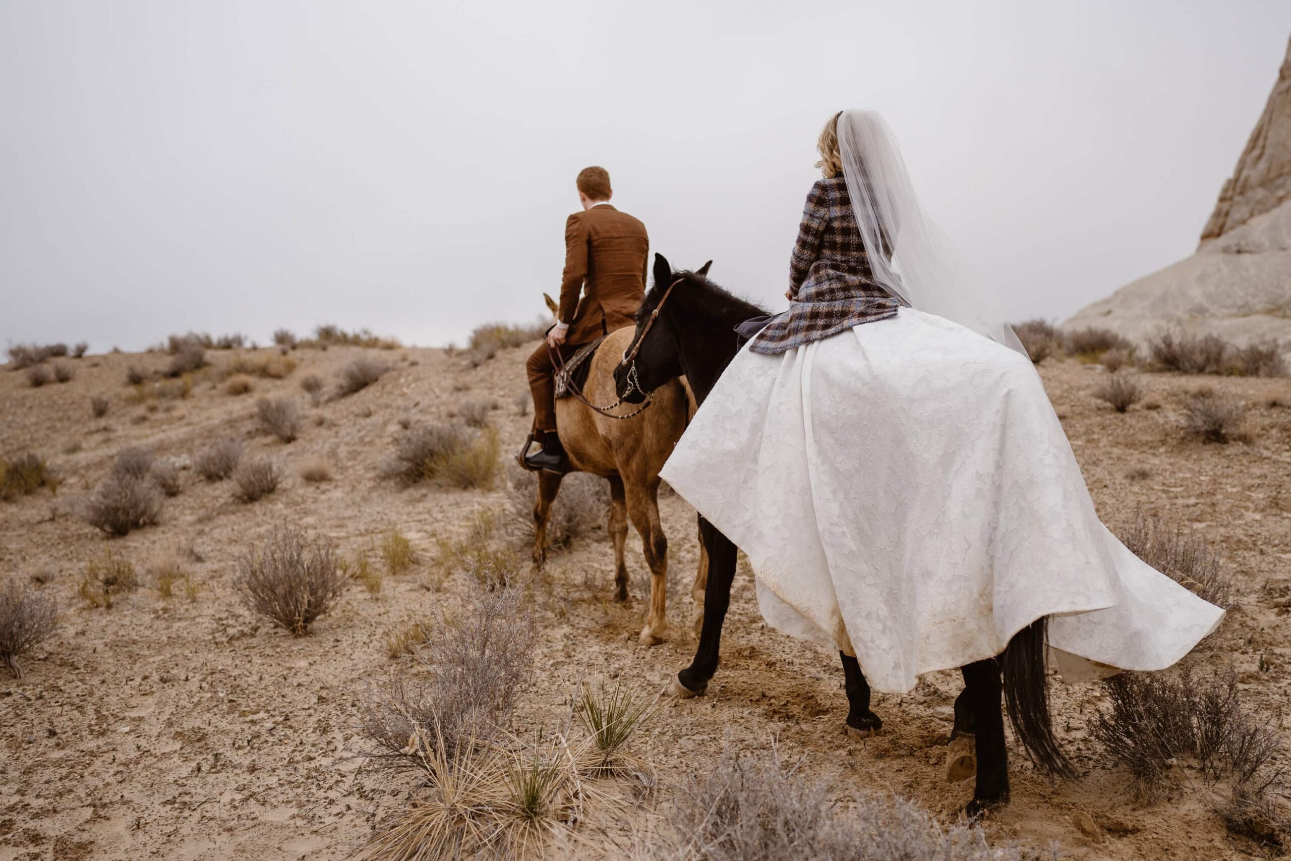 Bride and groom on horseback at Amangiri