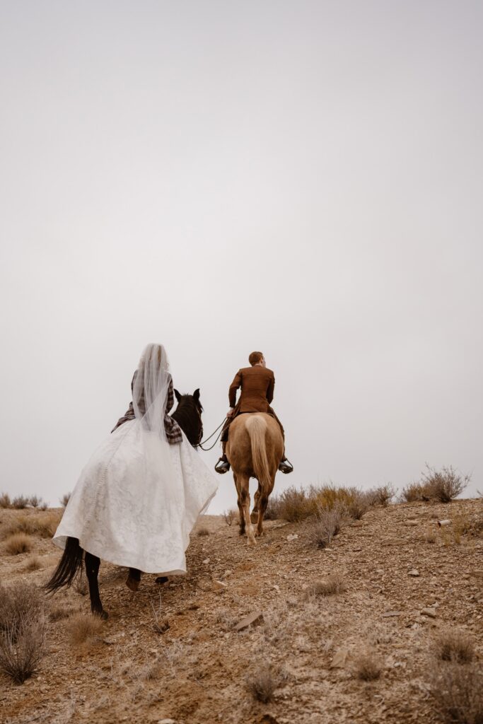Bride and groom riding off into the sunset on horseback