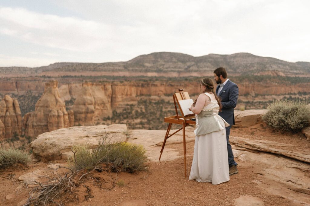 bride and groom painting their wedding ceremony site