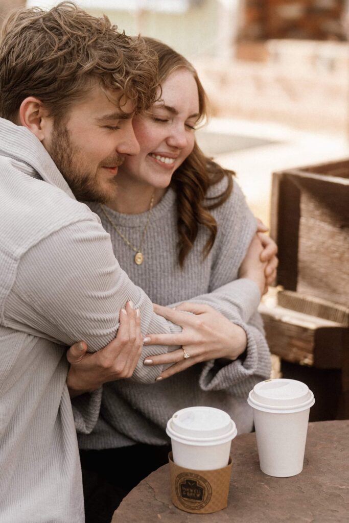 Couple hugging and sharing coffee