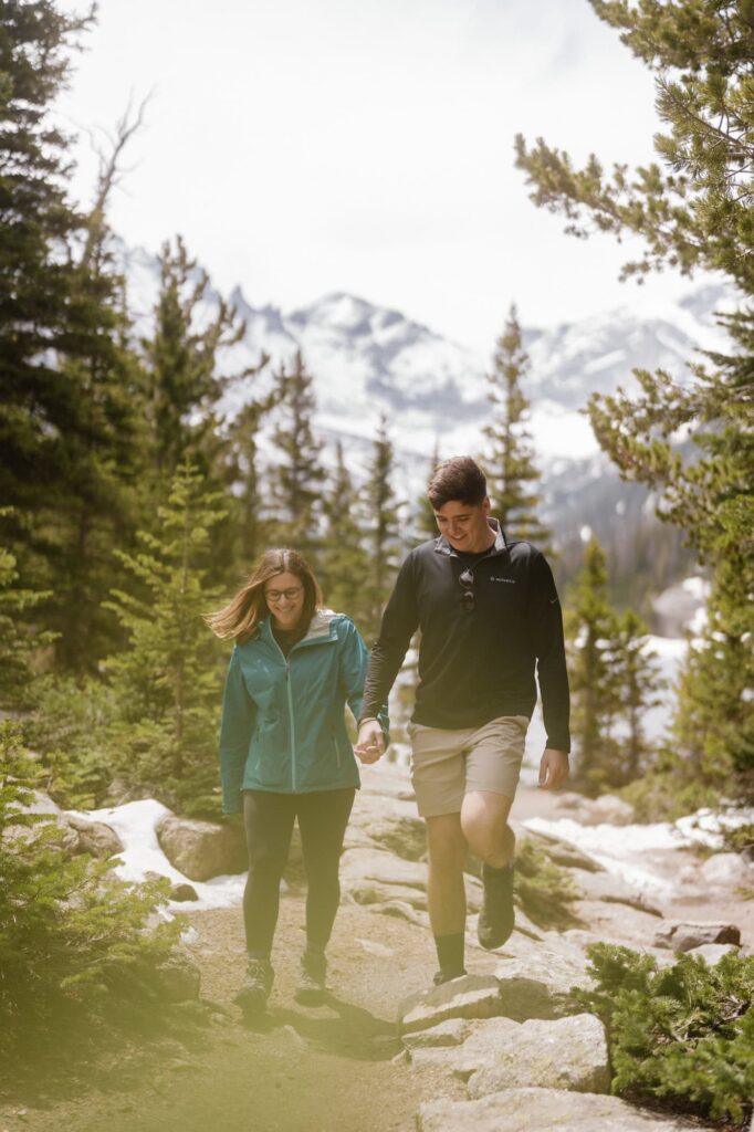 Couple hiking after surprise proposal in Colorado