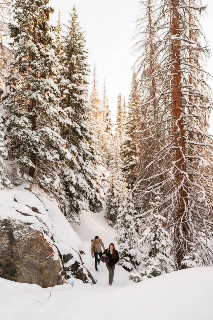 Couple hiking through snowy forest