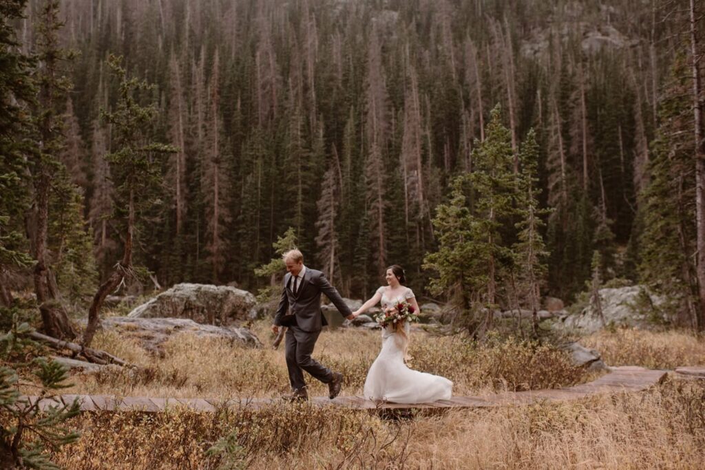 Bride and groom hiking through Rocky Mountain National Park