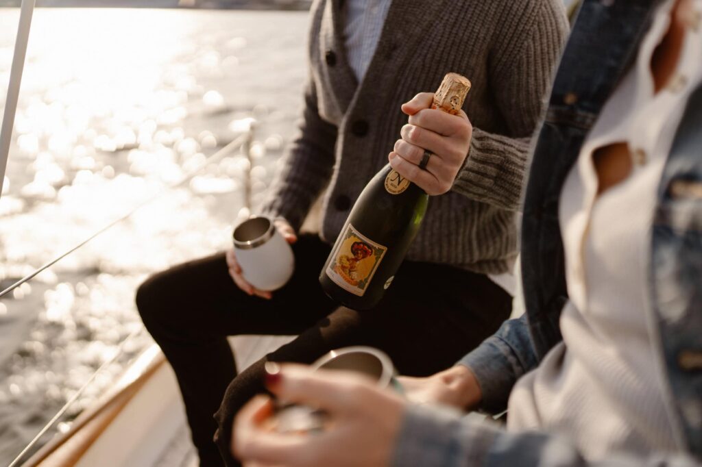Breaking out champagne for a sailboat couples photo session