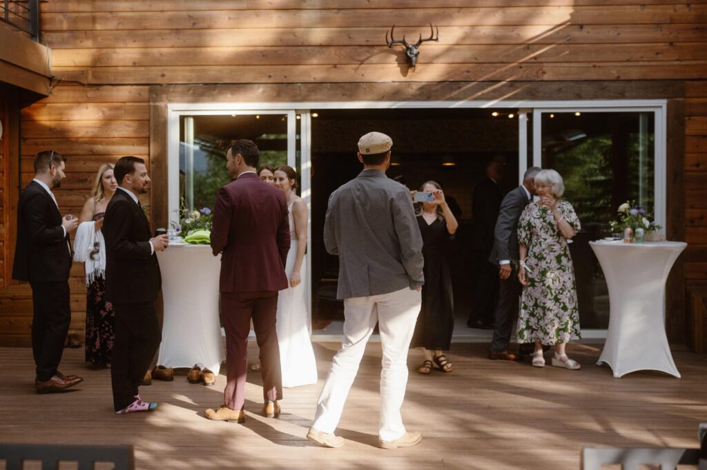Outdoor wedding reception and cocktail hour on patio at Juniper Mountain House
