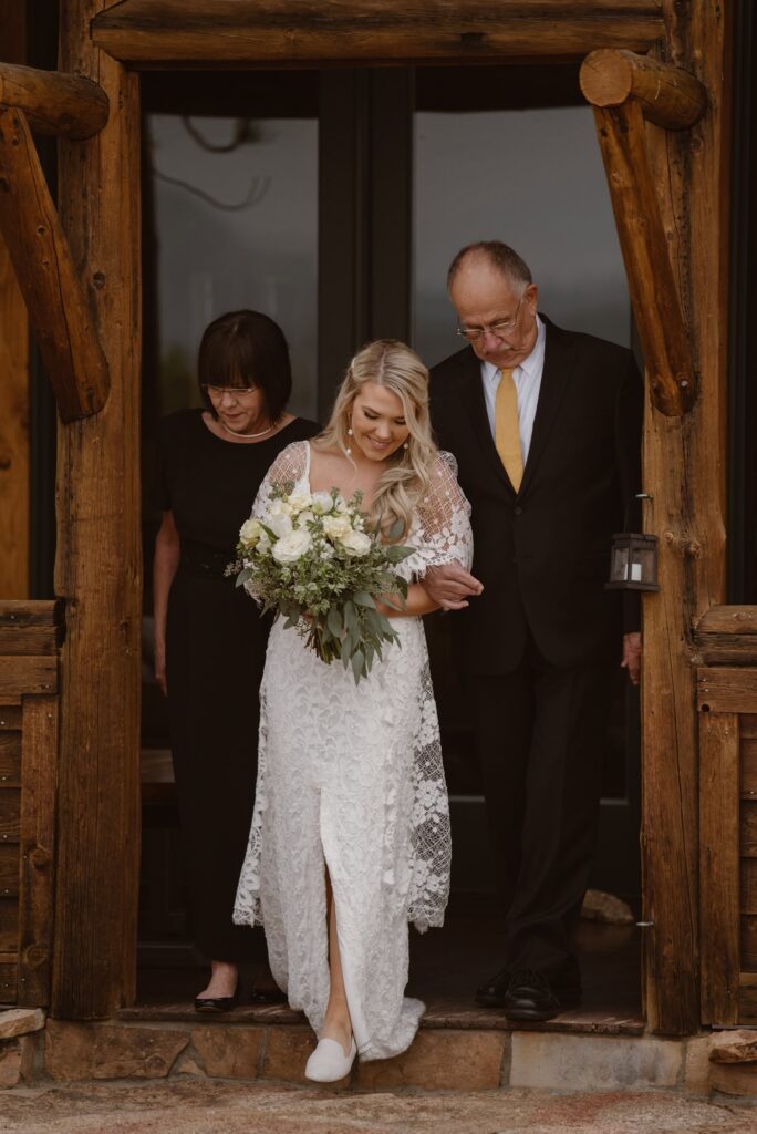 Bride walking down the aisle at Aspen Falls in Estes Park