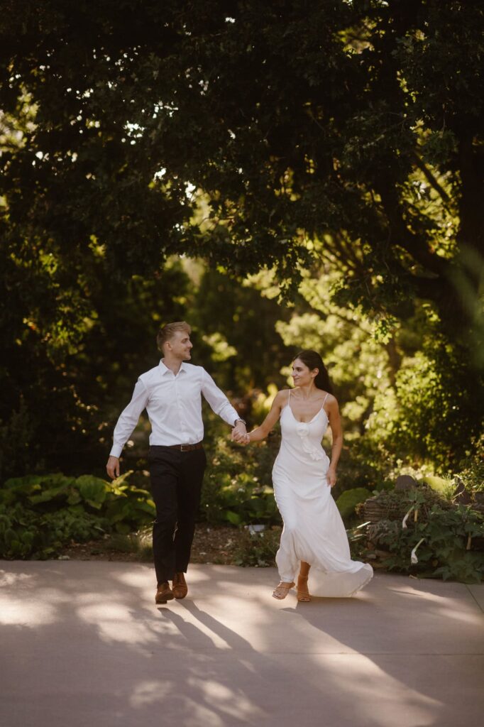 Couple running through Denver Botanic Gardens