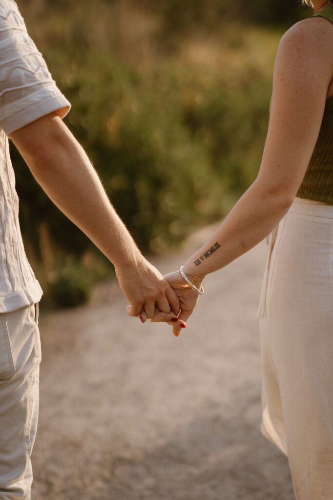 Couple holding hands during engagement photos