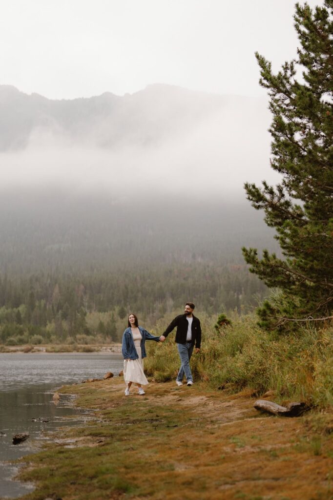 Couple walking along the shore of Lily Lake during moody September day