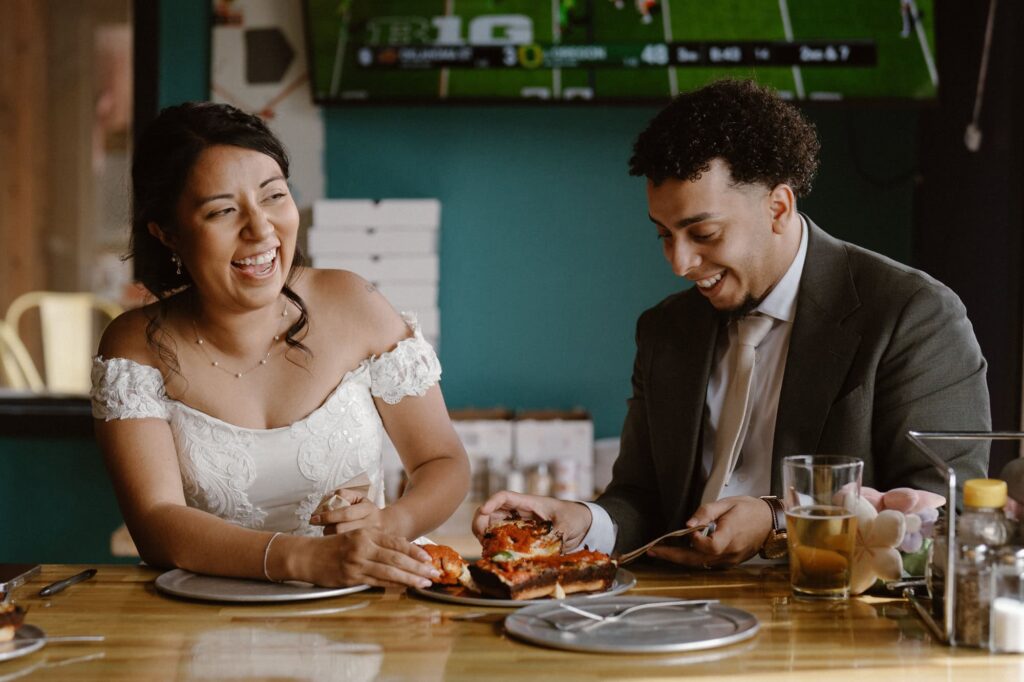 Bride and groom eating pizza
